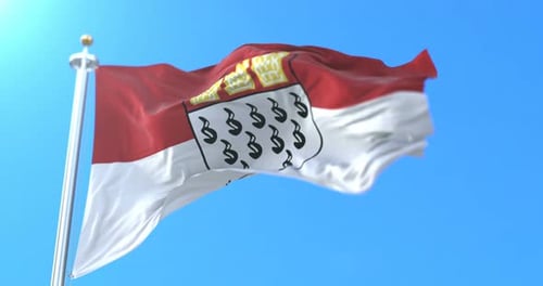 Waving Flag of Cologne City Germany Against Blue Sky
