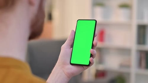 Rear View of Man Using Smartphone with Chroma Screen