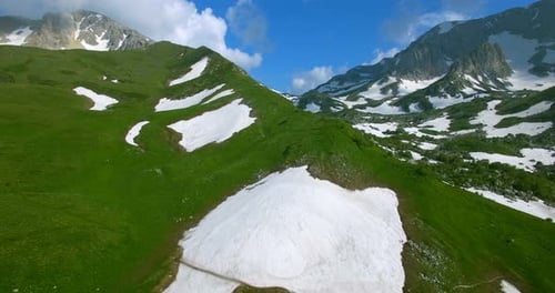Aerial View Mountain Pass With Glaciers And Green Grass In Mountains Of Caucasus