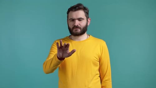 Male Using Invisible Touchscreen on Blue Studio Background