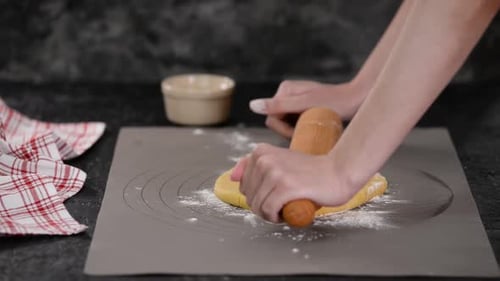 Arms Flattening Cookie Dough with Rolling Pin