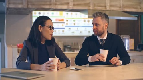Business People Discussing Project at a Counter