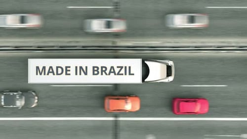 Trailer Trucks with MADE IN BRAZIL Text Driving Along the Highway