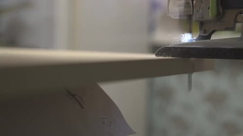 Master of Furniture Production Saws the Surface of the Table with an Electric Jigsaw 3