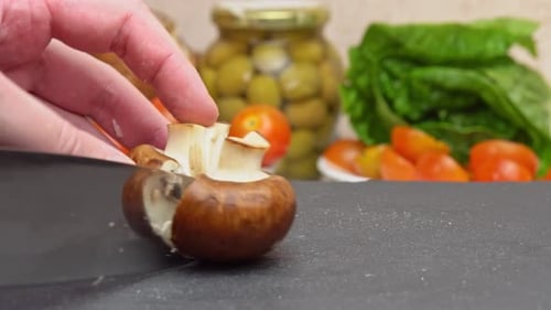 Chef Cuts Fresh Mushroom on a Cutting Board