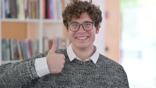 Smiling Man Giving Thumbs Up Gesture Indoors