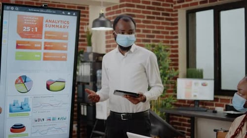 Business Team Presents Analytics in Office Meeting