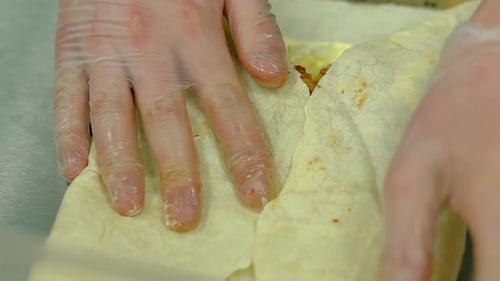 Gloved Hands Assembling Delicious Food Wrap
