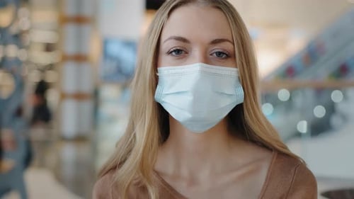 Blonde Woman Wearing a Mask Indoors