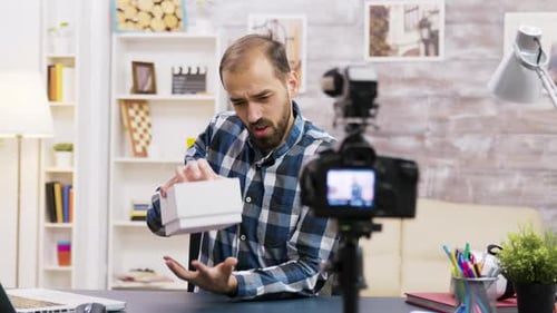 Young Adult Unboxes Smartphone On Camera