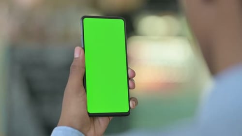African Man Using Smartphone with Green Chrome Key Screen