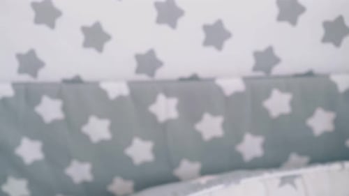 Calm Infant Lying in Crib with Pacifier