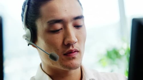 Young Adult Works in Tech Support with Headset