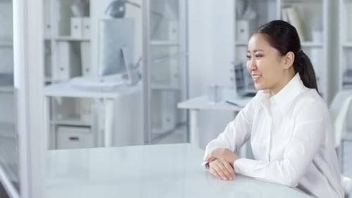 Asian Woman Having Video Call on Invisible AR Touchscreen in Office