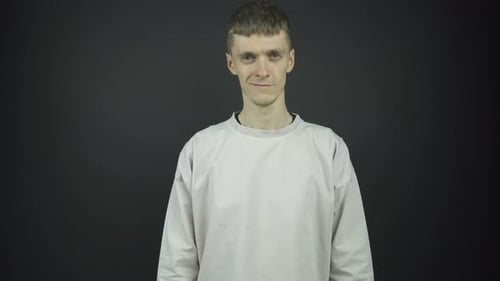Young Adult Smiling in Front of Grey Backdrop