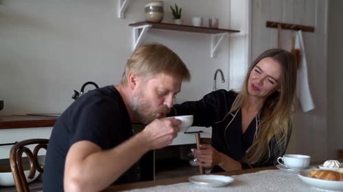 Affectionate Couple at Breakfast in Bright Kitchen