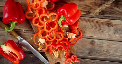 Vibrant Red Bell Peppers on Rustic Wooden Table