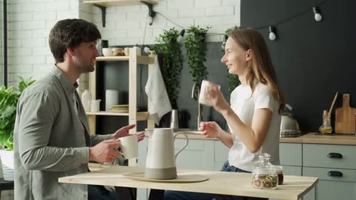 Couple Conversing over Coffee at Kitchen Table