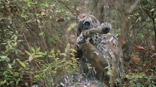Armed Young Soldier Sniper in a Zone of Armed Conflict in Uniform in Forest Slow Motion
