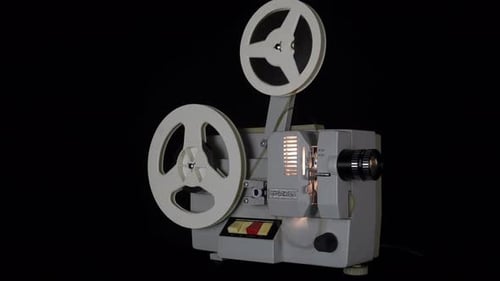 Vintage Film Projector Showing Light on Black Background