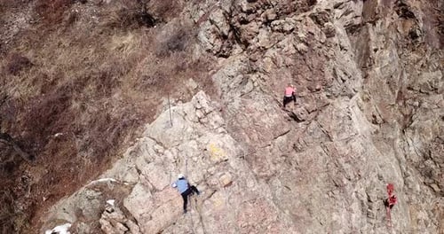 A Group of People are Engaged in Rock Climbing
