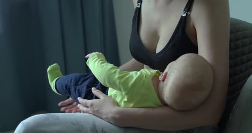 Unrecognizable Mom Holds Her Little Baby Boy on Hands in Room