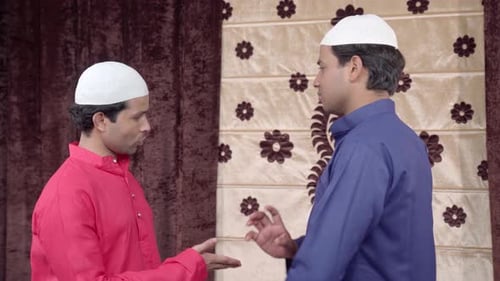 Men in Traditional Dress Engaging in Conversation