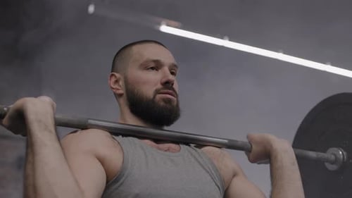 Bearded Man Lifting Barbell in Gym