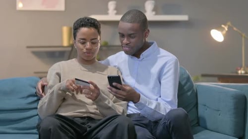 Couple Relaxing at Home Doing Online Shopping