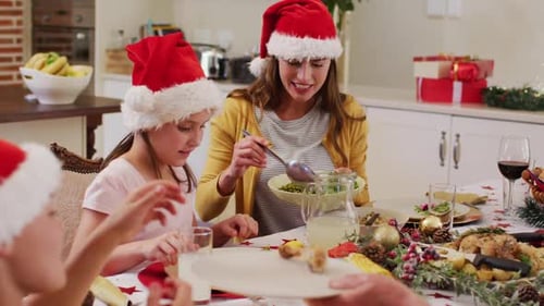 Family Celebrates Christmas Dinner Together at Home