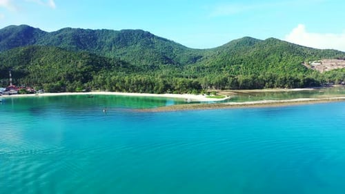 Luxury overhead tourism shot of a white sandy paradise beach and aqua blue ocean background in color
