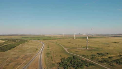 Aerial View of Wind Turbine on a Field in a Summer Day. Environment Friendly and Renewable Energy