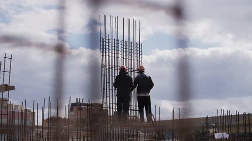 workers knit fittings at the construction site