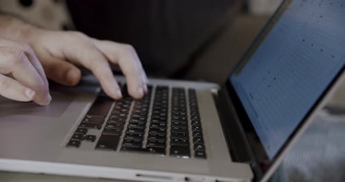 Hands Typing on Laptop Computer Keyboard Close Up