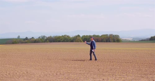 Agriculture Farmer Walking on Field.