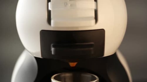 Espresso Machine Dispenses Coffee into Glass Mug