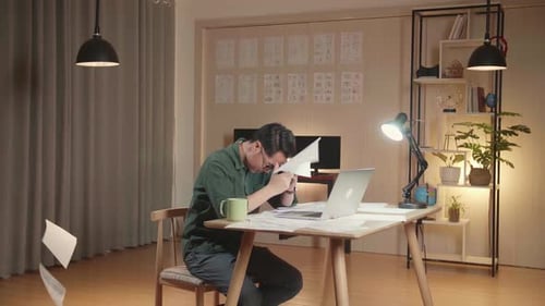 Upset Young Creative Designer Works On A Storyboard, Looks At His Sketches And Throw Papers