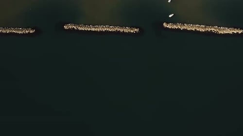 Drone Flying Over Epic Mediterranean Sea Coast with Wave Breakers Revealing Wonderful Sandy Beach