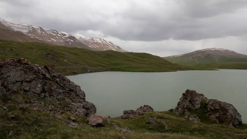 Timelapse of Running Clouds in the Lake in Mountains