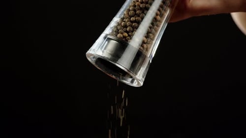Fresh Ground Pepper Falling From Pepper Mill
