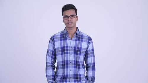 Young Adult in Blue Flannel Shakes Head