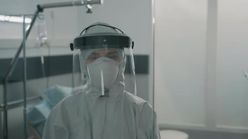Healthcare Worker in Protective Gear Standing in Hospital