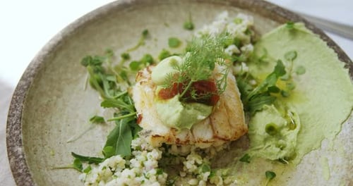 Gourmet Fish Dish with Fresh Herbs and Sauce