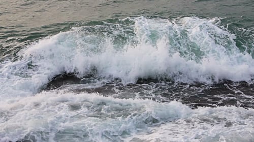 Waves Crashing on Rocky Coastline