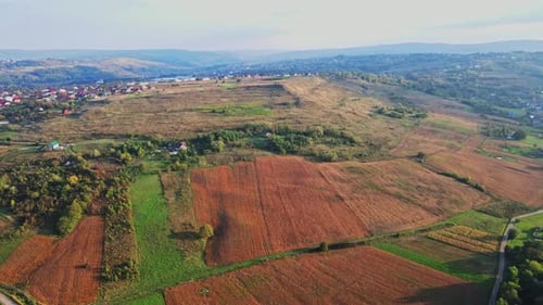 Ukrainian fields stretch on the hills near the settlements Aerial view