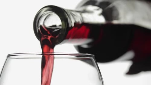 Rose Wine. Red Wine Pour in Wine Glass Over White Background