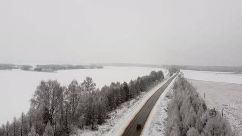 Aerial Top View To the Cars Driving on the Snow Road in Winter Time