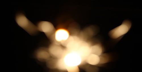 Sparkler Creates Glittering Light Orbs in Darkness