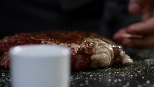 Pouring Olive Oil on Meat