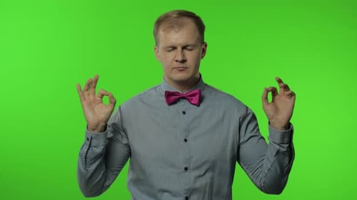 Blond Man Meditating on Green Screen Background